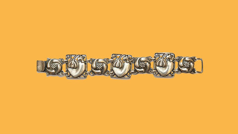A romantic sterling silver hearts and flowers bracelet signed McClelland Barclay and made in the late 1930s by Rice-Weiner & Co.
