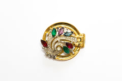 late Art Deco or Art Moderne gold plated swirl brooch with colorful navette stones from the late 1930s