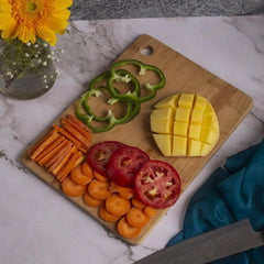 Wooden chopping board with Fruits and Veggies