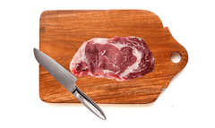 Wooden chopping board with meat