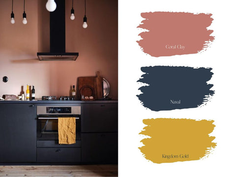 Modern kitchen featuring navy cabinetry, a coral wall, and black and mustard fixtures. Includes a palette of 3 spring colors.