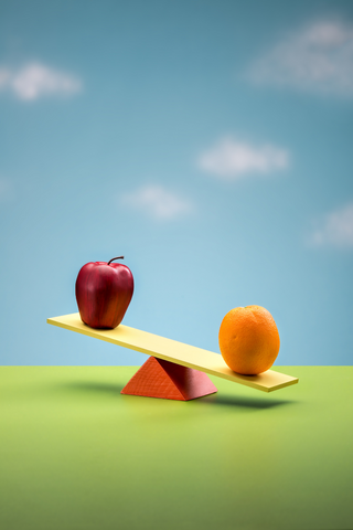 Apple and orange on a seesaw
