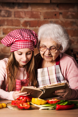 Grandma cooking with her granddaughter