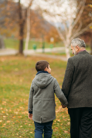 Grandfather walking with grandson