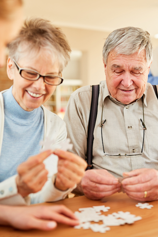 Elderly couple doing a puzzle