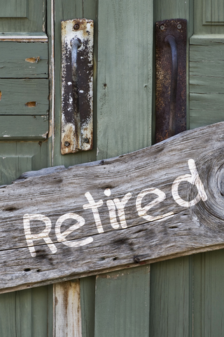 'Retired' sign on a wooden door