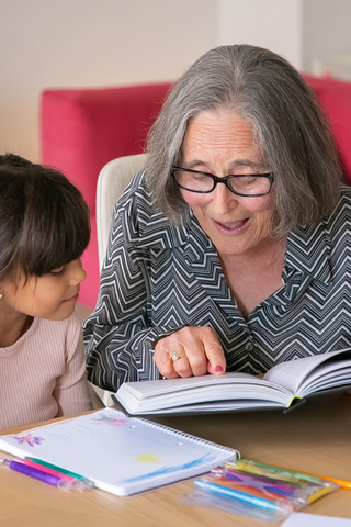 Grandma reading to her granddaughter