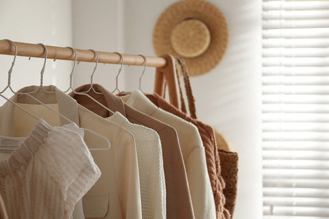 a collection of jackets and tops in cream and tan colors