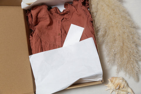 rust coloured linen top in a brown box