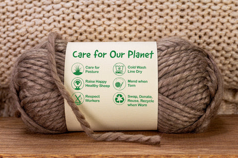 a ball of brown sustainable wool wrapped in a label which reads ‘Care for Our Planet’