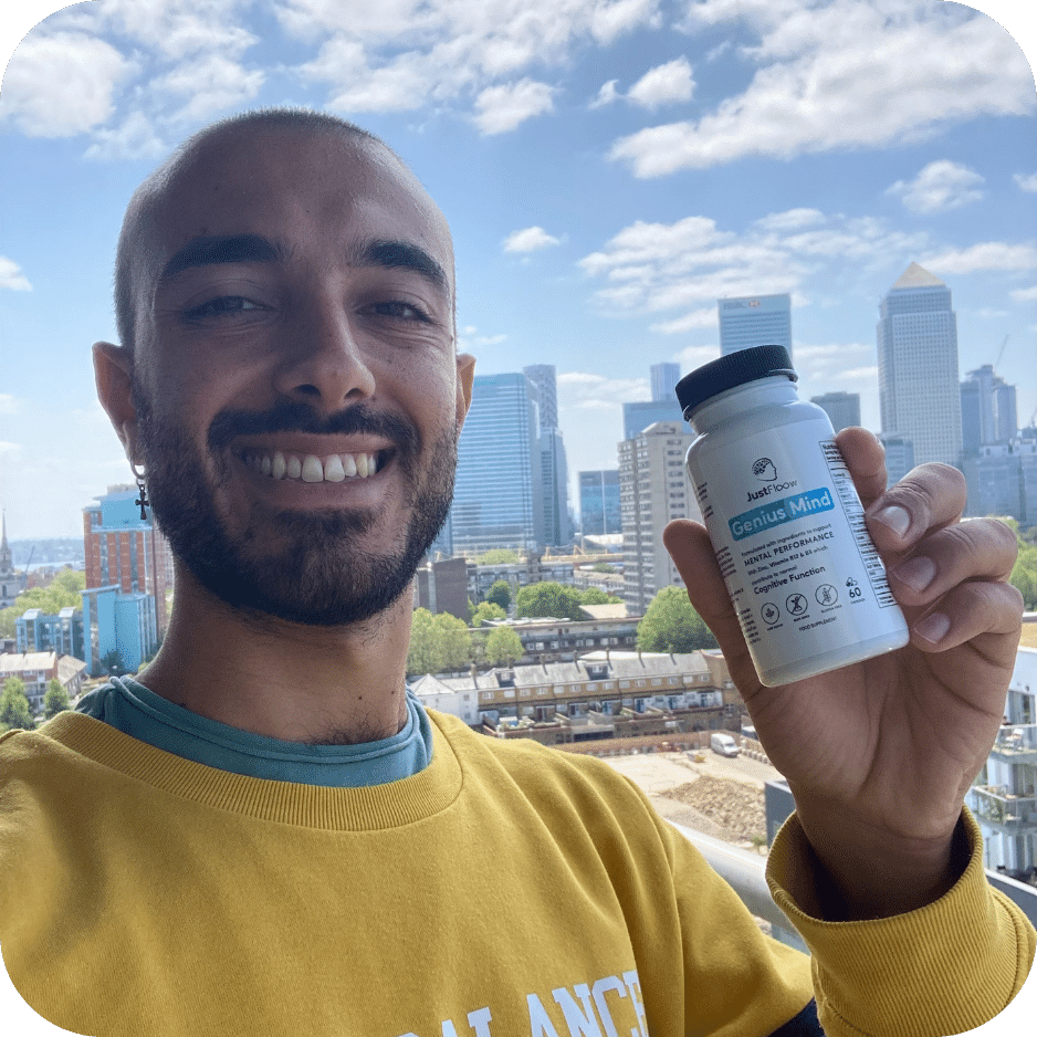 Man holding a supplement bottle with city skyline in the background.