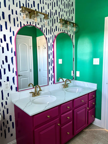 image of a bathroom vanity - green wall, pink cabinets, blue and white pattern wall