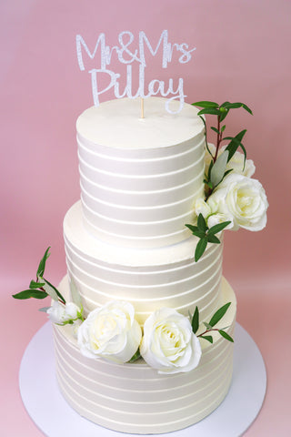 Two Tiered Wedding Cake With White Roses And Cake Topper