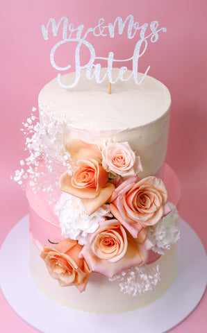 White and pink wedding cake with roses