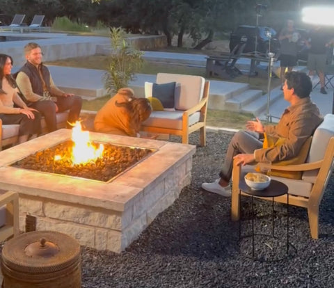 Four People Sitting on heated outdoor furniture from Outmore Living around a firepit