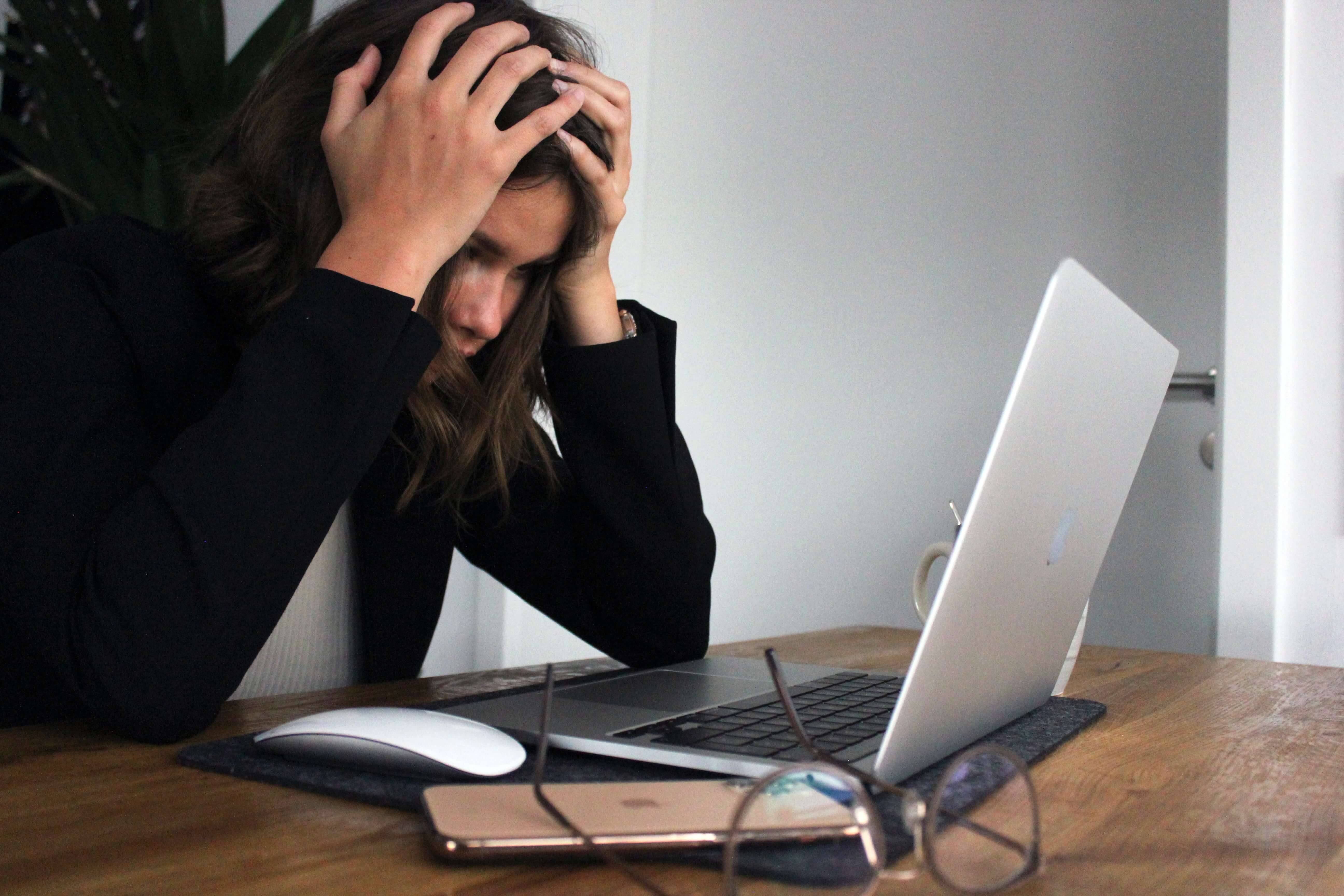 A nervous person sitting in front of the laptop.