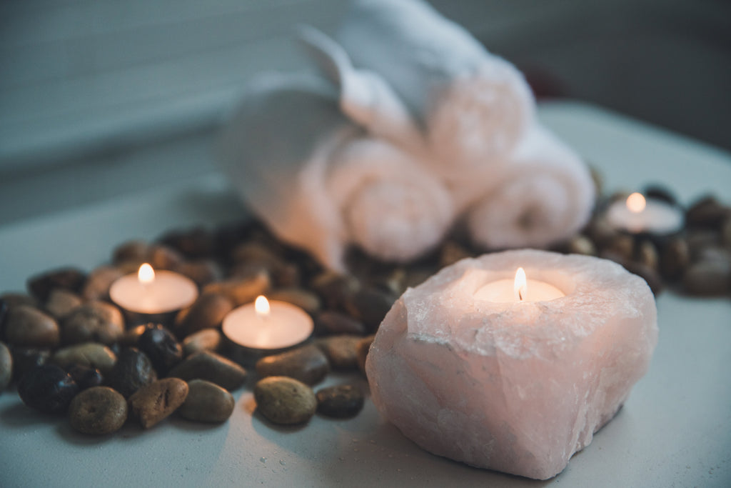 Candles stones and rolled towels
