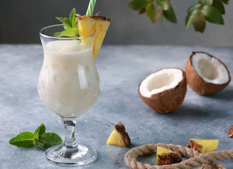 Pina Colada; a fluffy, white cocktail with foam on top with an exotic taste.