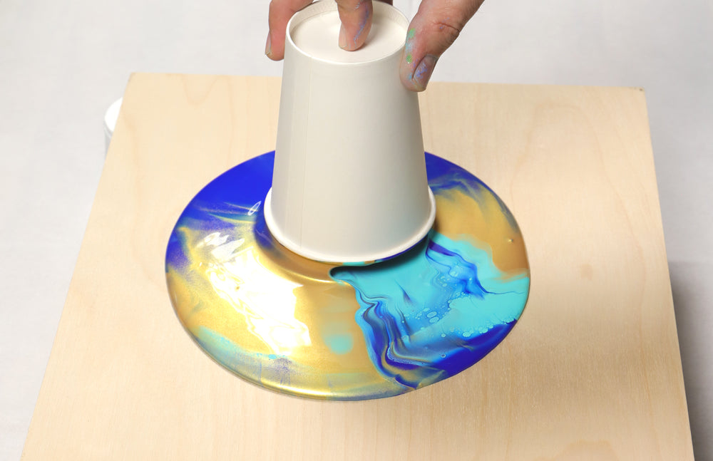 A fluid painting with cup pour.