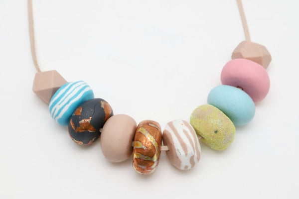 Polymer clay beads on a necklace.