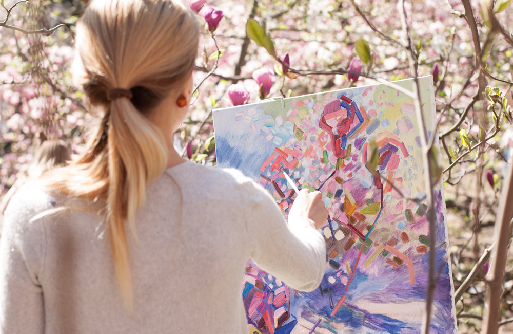 Female painting an abstract landscape painting.