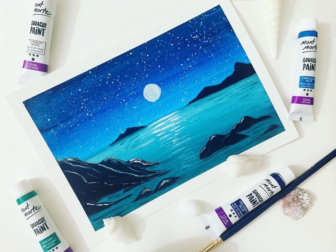 Ocean artwork painted in gouache with gouache tubes around it.