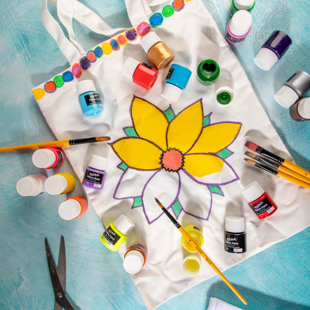 1. Mont Marte Fabric Paint being used on a tote bag to paint a flower