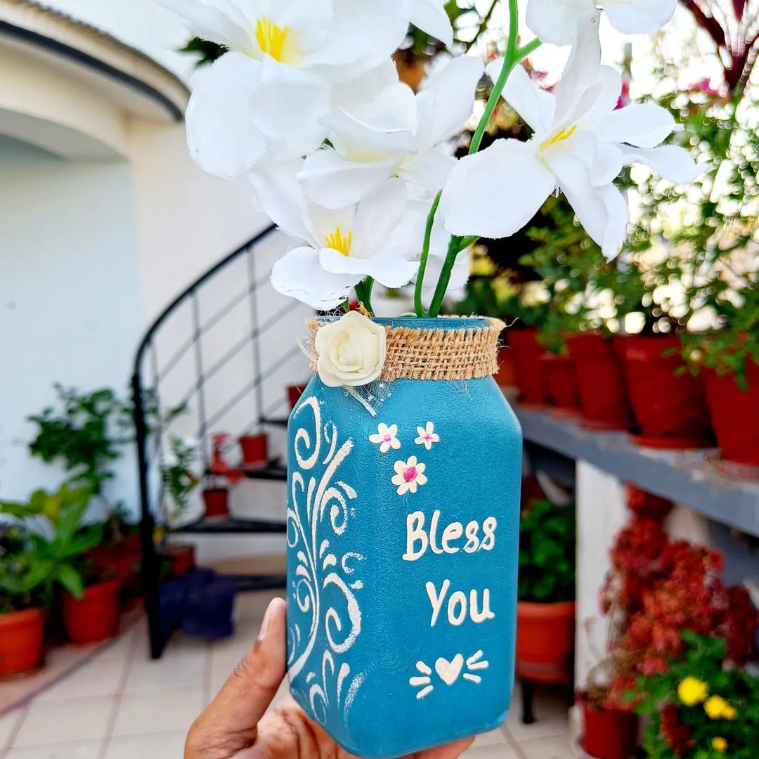 1. @poonam_diy_with_creativity upcycled jar painted blue with white script and design