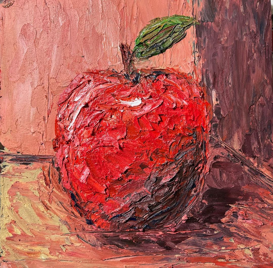 10. An oil painting of a red apple created on a board using a palette knife.