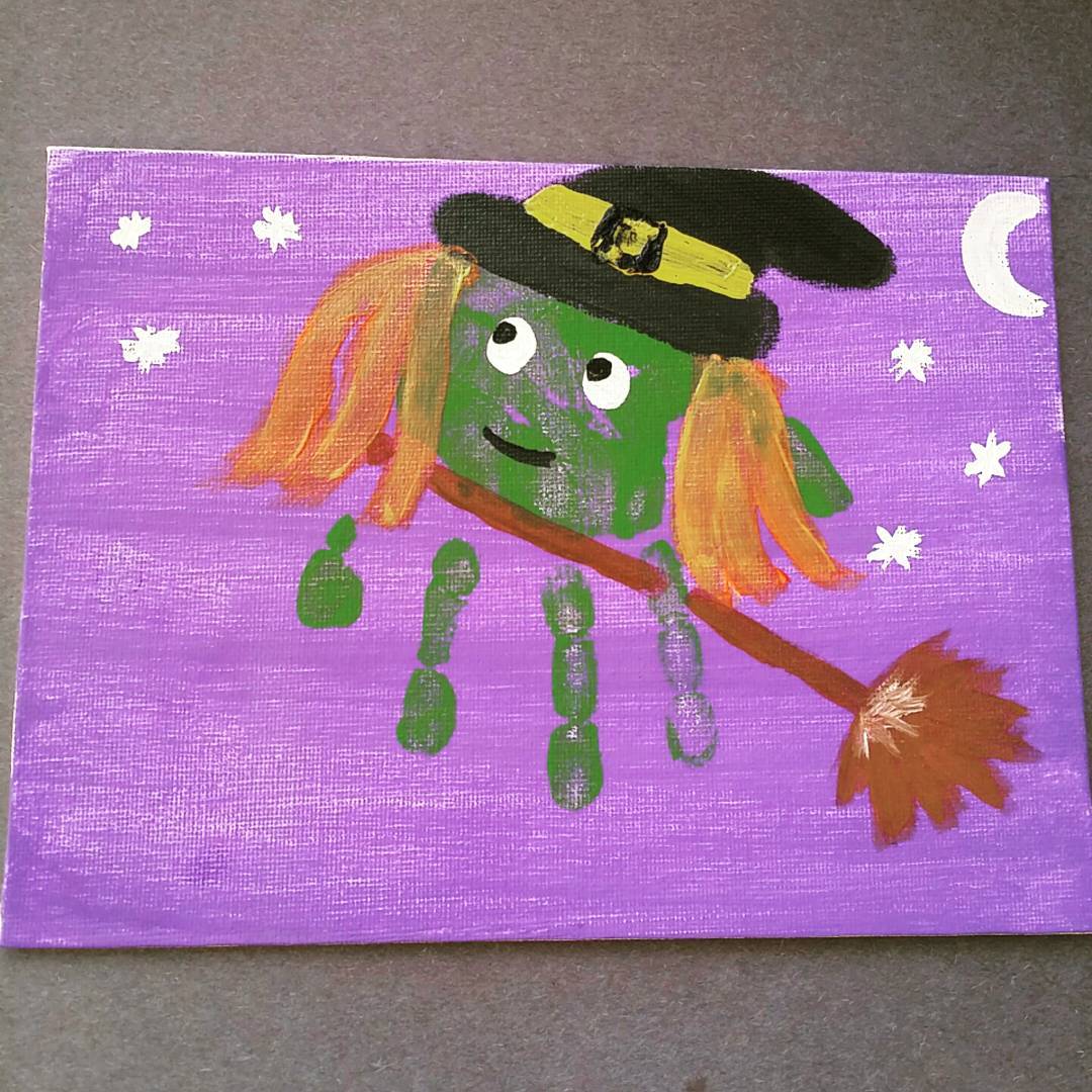 Child's handprint painted on canvas to look like a Halloween witch.