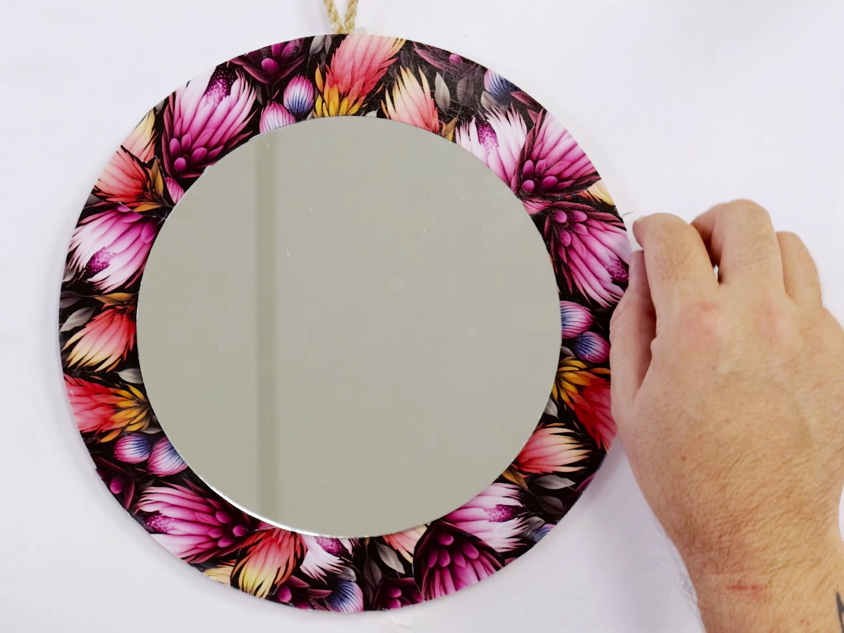 10. Decoupaged dark floral mirror with string for hanging