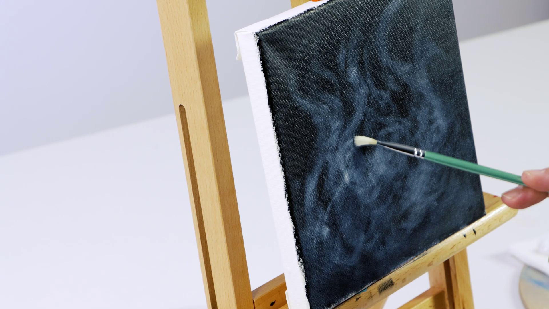 10. White paint scumbled onto a black painted canvas