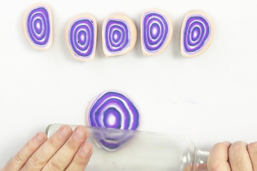 Hand rolling agate geometric coasters with a rolling pin.