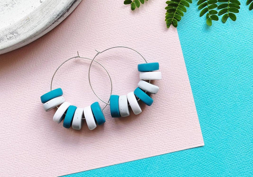 Blue and white lifesaver-style beads on gold hoops.