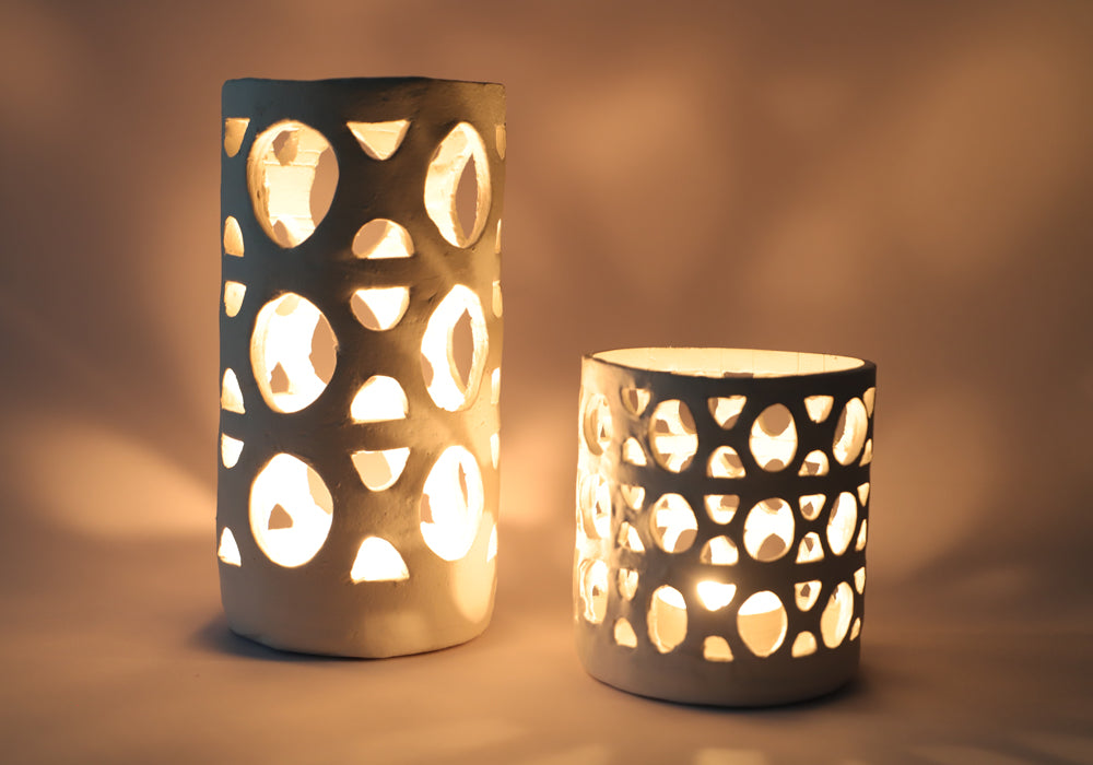 Two air dry clay lanterns with lights inside.