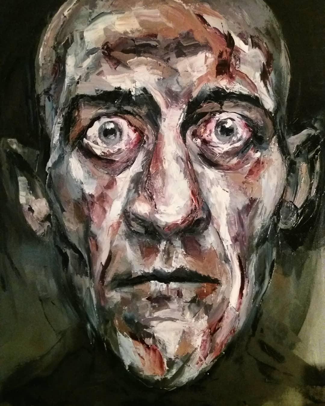 12. Portrait of a man with wide, bloodshot eyes created using palette knives.