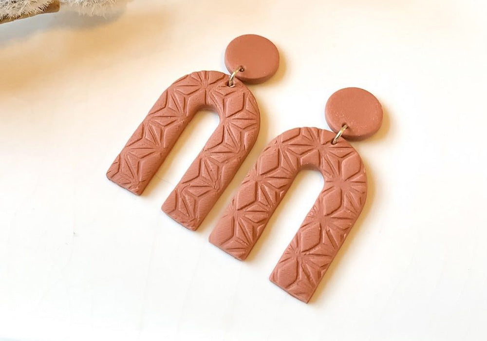 Imprinted earrings with squiggly textures.