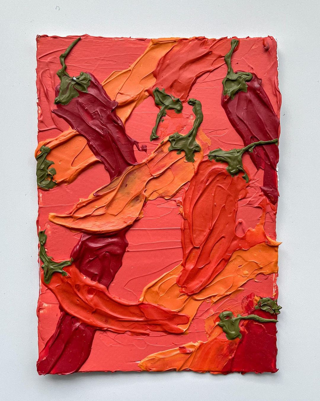 17. A textured acrylic painting of various chillis in red and orange.