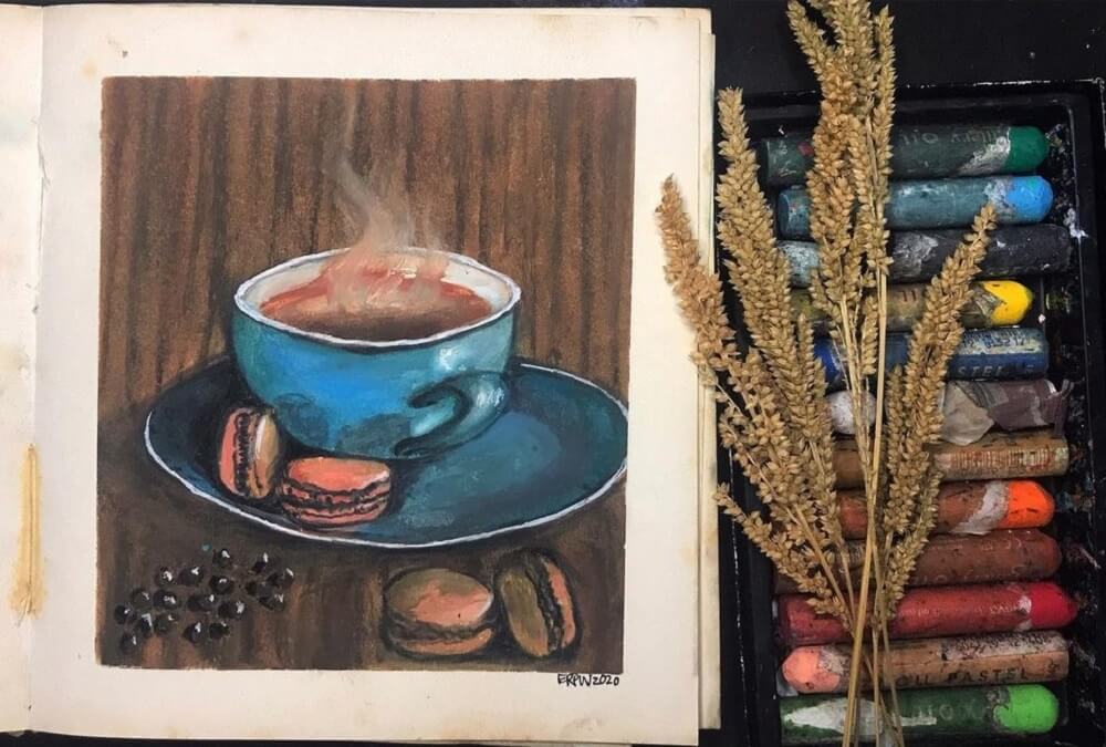 Sketch book of an oil pastel drawing of a hot coffee mug.