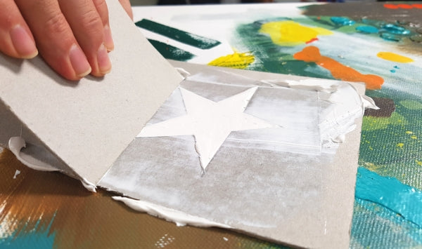 Hand creating a 3D star stencil using Modelling paste.