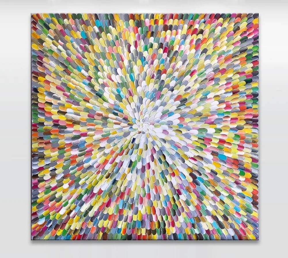 Colourful circular canvas with a rainbow of paint placed like flower petals.