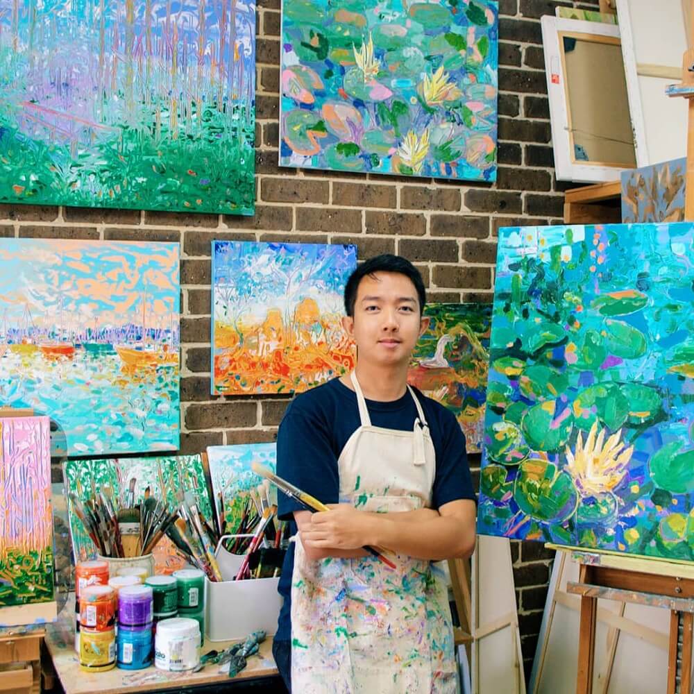 Joseph Villanueva in his studio with artworks.
