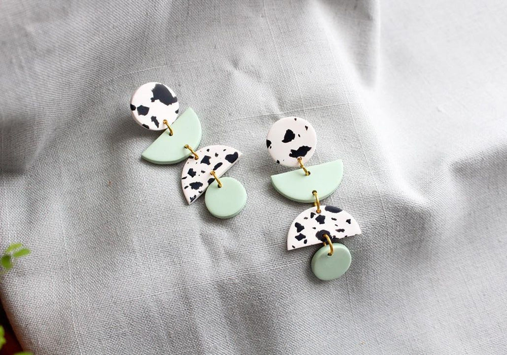 Two pairs of animal print earrings.