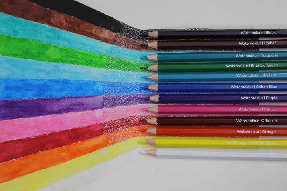 A rainbow made from 12 watercolour coloured pencils with each coloured pencil swatch align with the pencil shade.