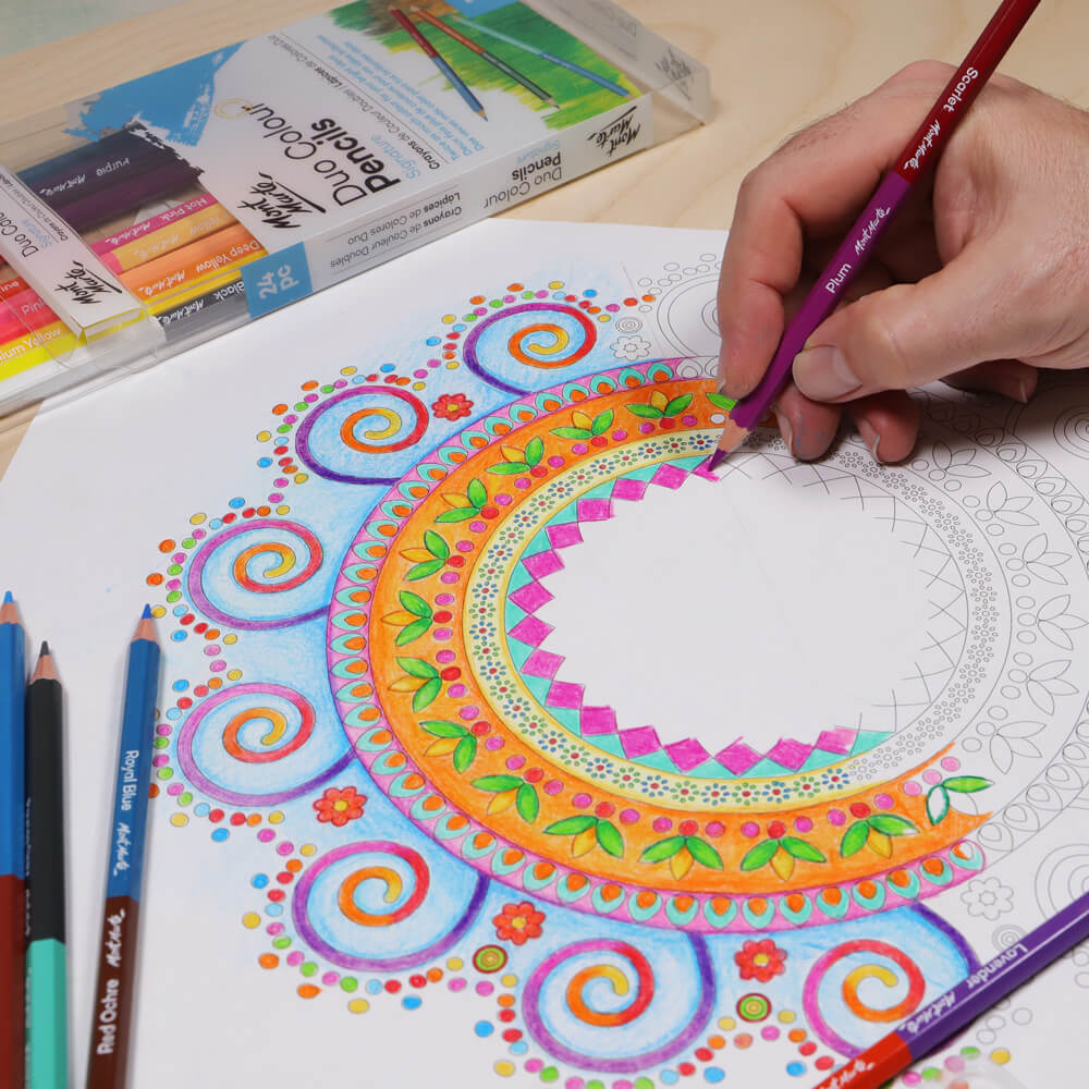Hand colouring in a colourful mandala design with dual ended pencils.