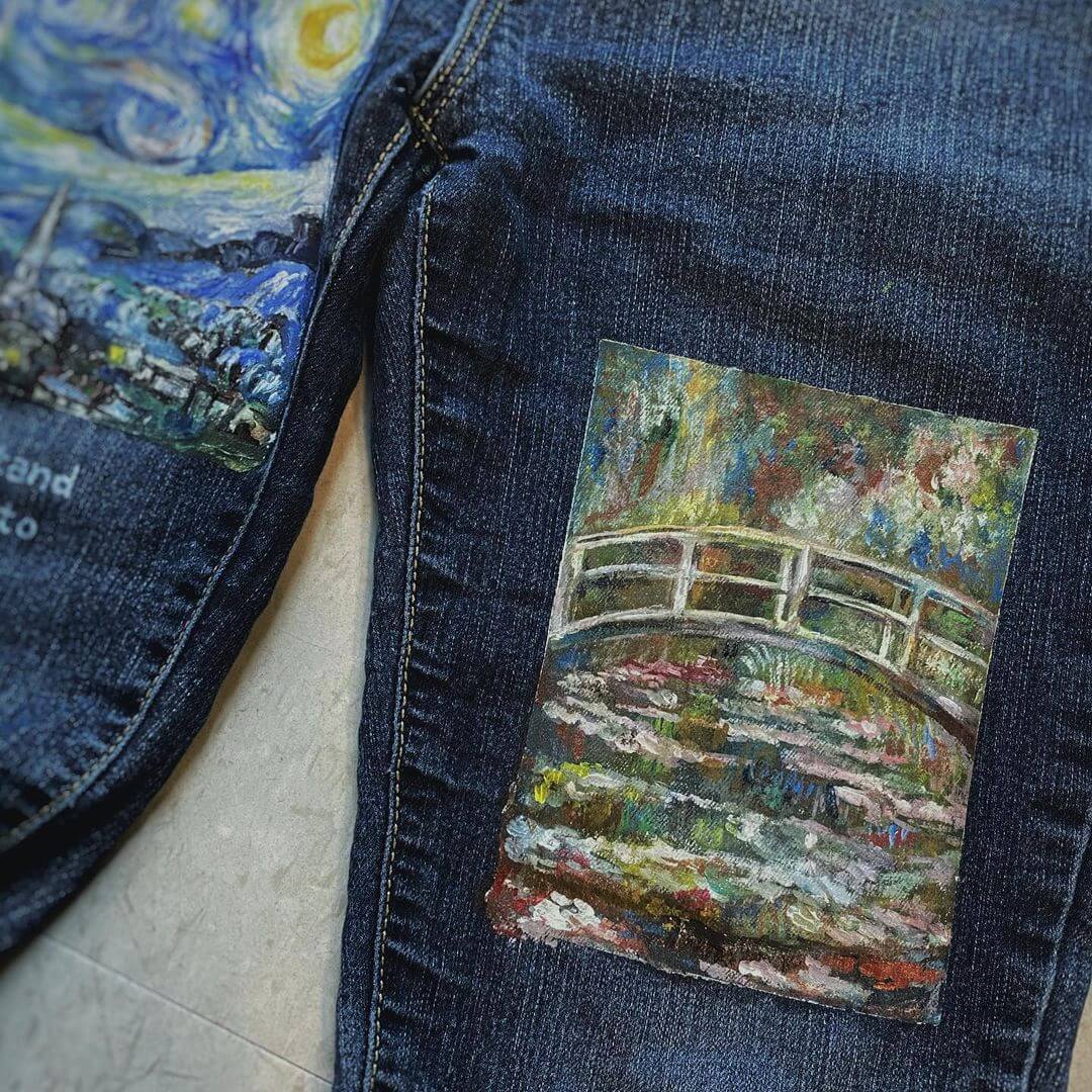 Monet's waterlily pond artwork painted on a pocket of a pair of blue jeans.