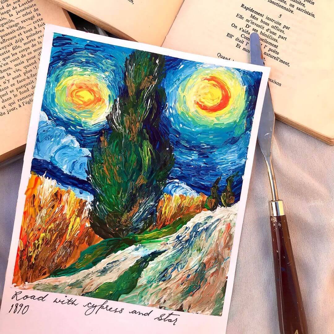 2. Van Gogh inspired starry night artwork layed on top of a book with a palette knife next to it.