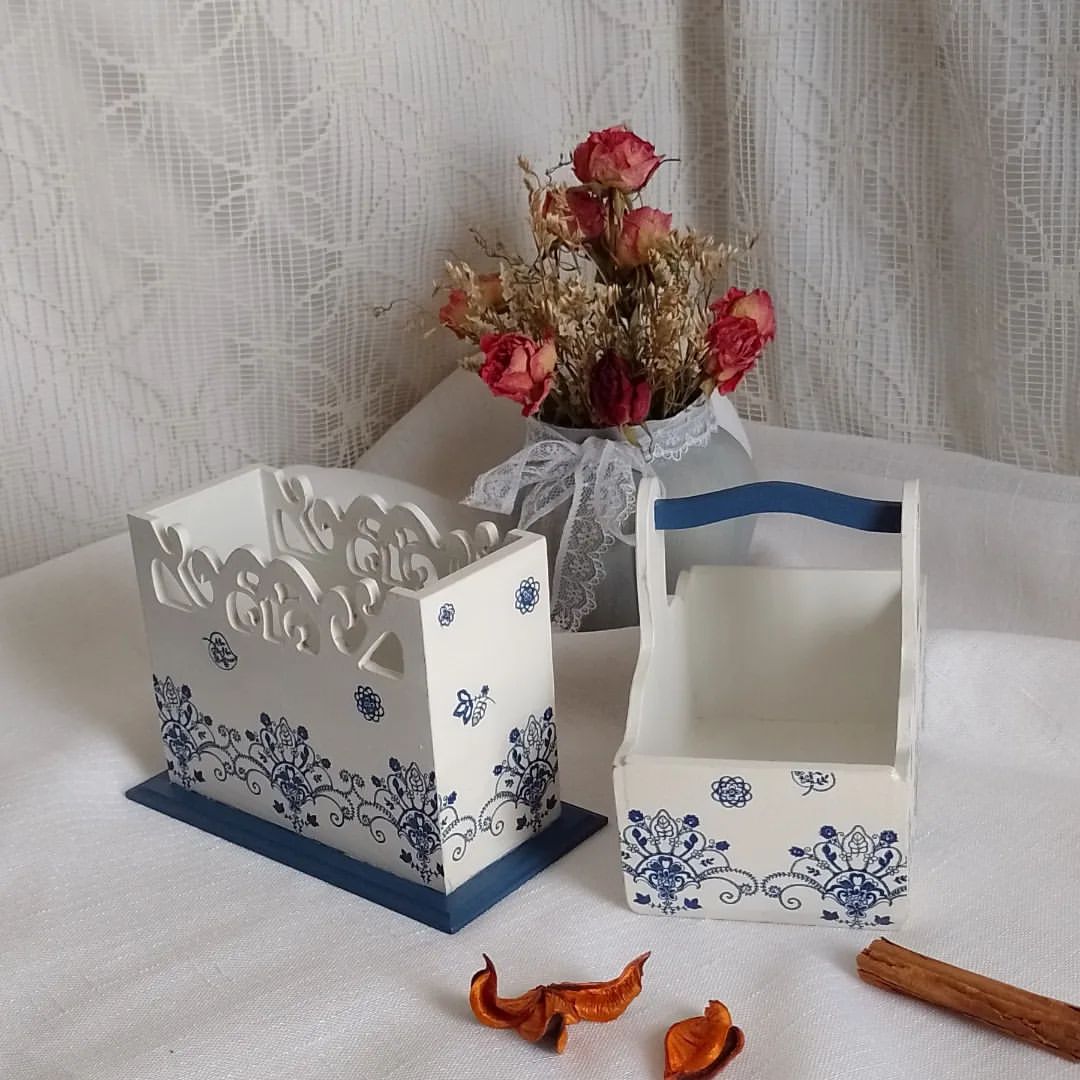 2. White decorative storage boxes with decoupaged lacey blue patterns