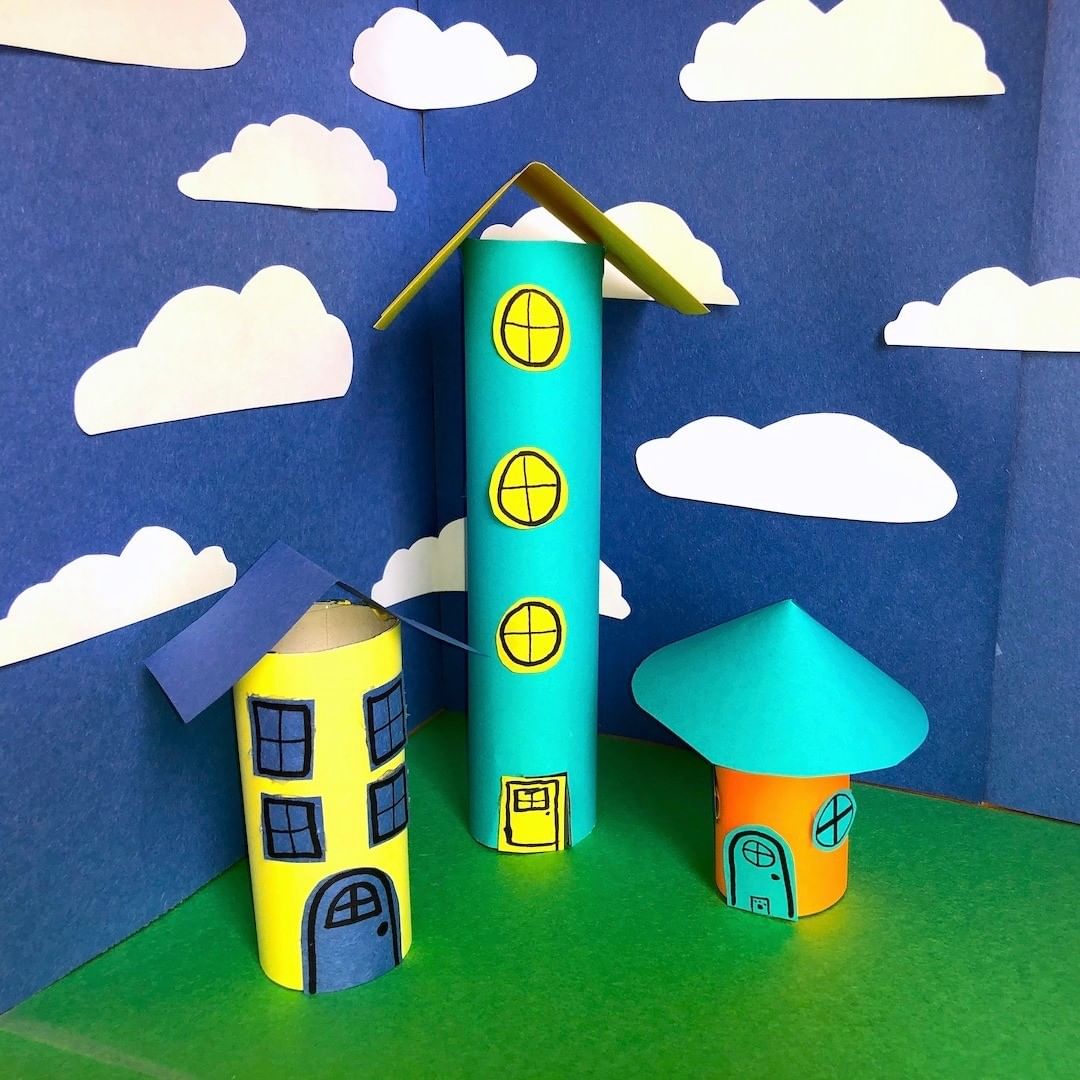 2. @themusekenora Paper craft city with a paper sky background