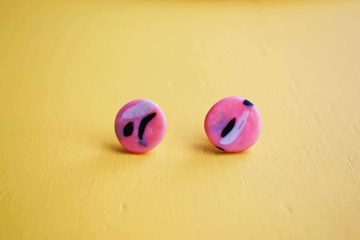 A pair of pink polymer clay studs.